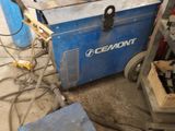 a blue machine that is sitting in a garage