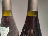 two bottles of wine sitting next to each other on a table