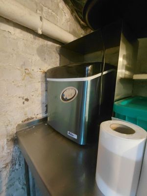 deux rouleaux de papier toilette posés à côté d'un grille-pain sur un plan de travail