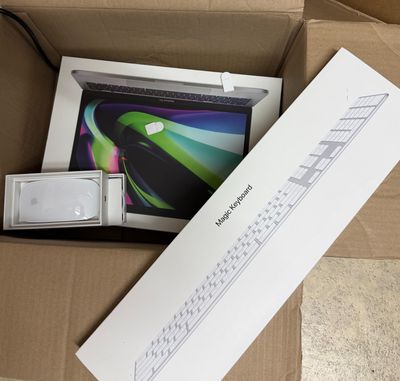 a box that has a laptop in it and a keyboard in it