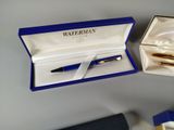 a blue box with a fountain pen inside of it