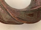 a close up of a bronze bracelet with a bird on it