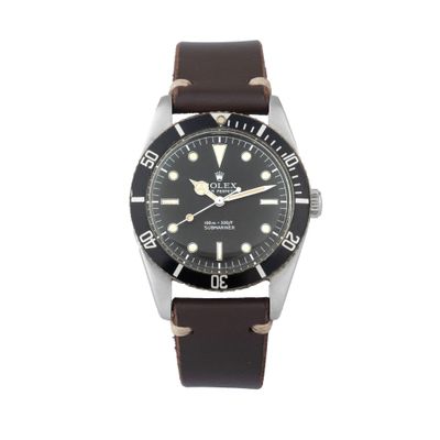 a close up of a watch on a white background with a brown strap