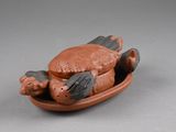 a small figurine of a cat on a plate