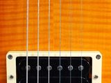 a close up of an electric guitar with strings