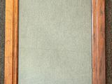 an old wooden frame with a green background