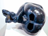 a blue sculpture of a fish on a white surface