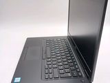 a laptop with a black keyboard on a white surface
