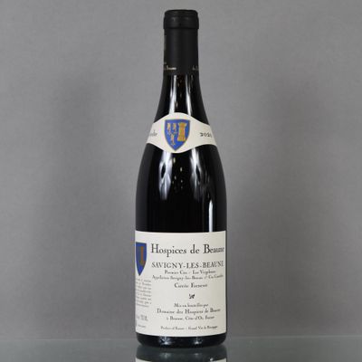 a bottle of red wine sitting on top of a glass table