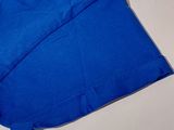 a close up of a blue shirt on a white surface