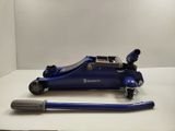 an image of a blue hydraulic jack on a white surface
