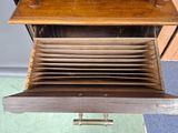 a wooden drawer with a bunch of plates in it