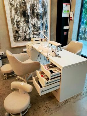 a white desk with a chair and a computer on it