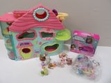 a littlest pet shop with toys and accessories on the table