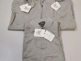 three men ' s polo shirts with tags on them sitting on a table