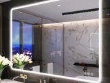 a large mirror above a sink in a bathroom