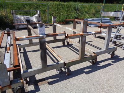 a metal frame that is sitting on wheels in a parking lot