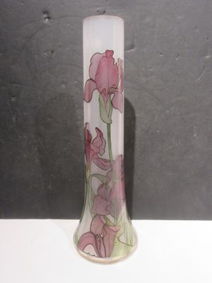 a glass vase with pink flowers on it on a table