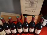 several bottles of red wine are lined up on a table