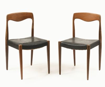 pair of chairs with black leather seats and wooden legs