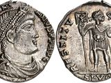 a silver coin with an image of a man holding a sword