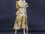 statue of a man holding a baseball bat on a black background