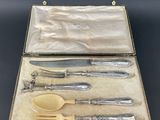 an antique silverware set in a leather case on a table