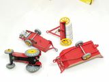 four toy tractors that are sitting on a white surface