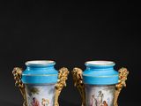 pair of blue and gold vases with figures on them