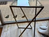 a glass table with a bird on it in front of a window