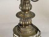 a close up of a lamp on a table with a chain around it