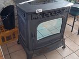 a stove sitting in the corner of a room next to a table