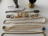 many different types of necklaces and bracelets laid out on a table