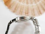 a close up of a watch on a white surface