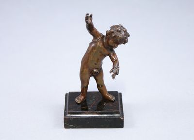 bronze figurine of a boy throwing a ball on a marble base