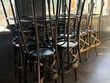 tables and chairs in a room with a chalk board on the wall