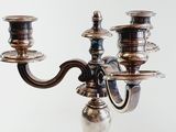 a silver candelab with three candles on it