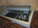 une vitrine en verre contenant des casseroles en argent