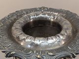 a silver vase that is sitting on a table