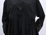 a black coat with fur collar and cuffs on a mannequin mannequin mannequin mannequin mannequin mannequin mannequin mann