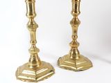 pair of antique brass candlesticks on a white background
