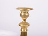 a gold candle that is sitting on a table