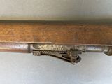 a wooden table that has a metal handle on it