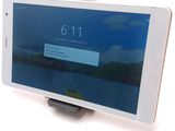 a tablet that is sitting on a stand on a table