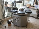 a machine that is sitting in a kitchen with a lot of pots on it