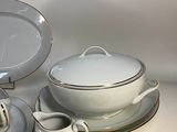 a lot of plates and bowls that are on the table