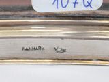 an image of a close up of a silver plate with a clock on it