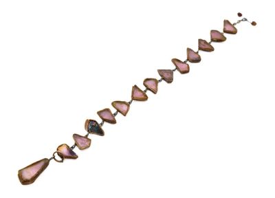 a close up of a bracelet with pink stones on a white background