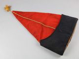 a red and black hat on a white table