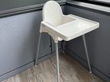 a baby high chair in the corner of a room